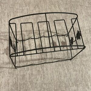 Four bottle wine rack with slot for glasses.